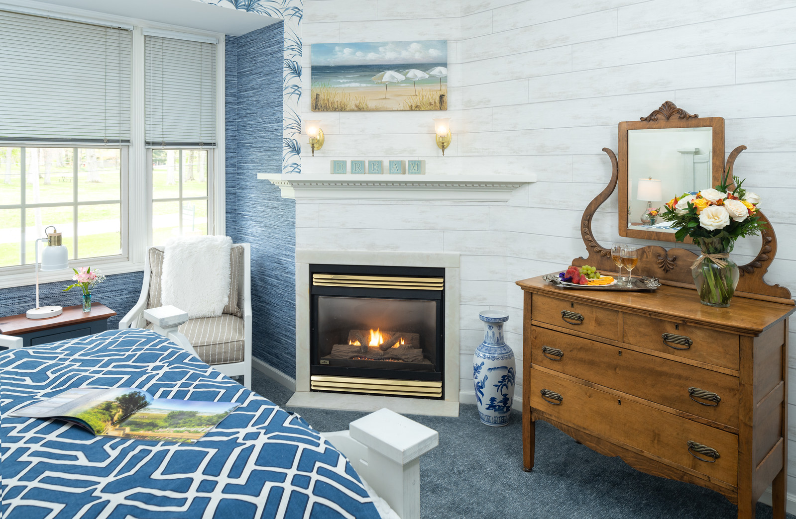 white queen bed by fireplace