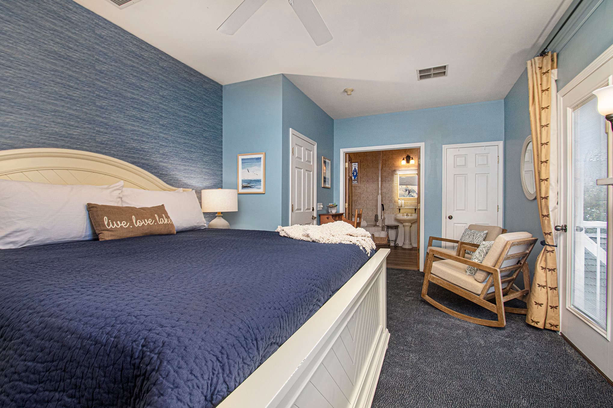 king bed sitting area fireplace and tv