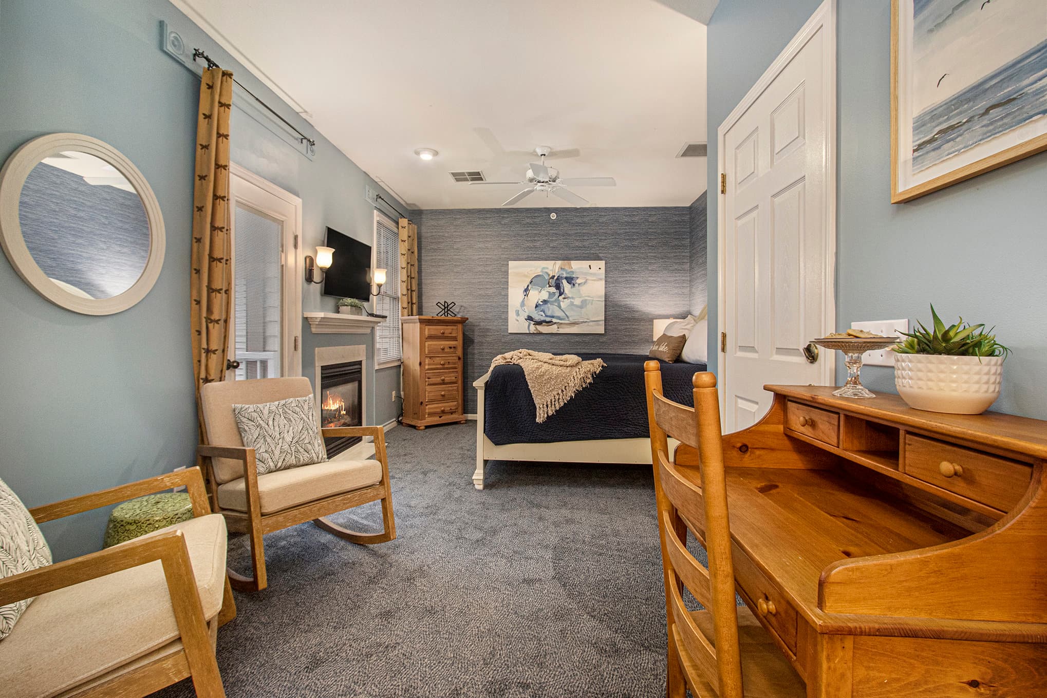 king bed sitting area fireplace and tv