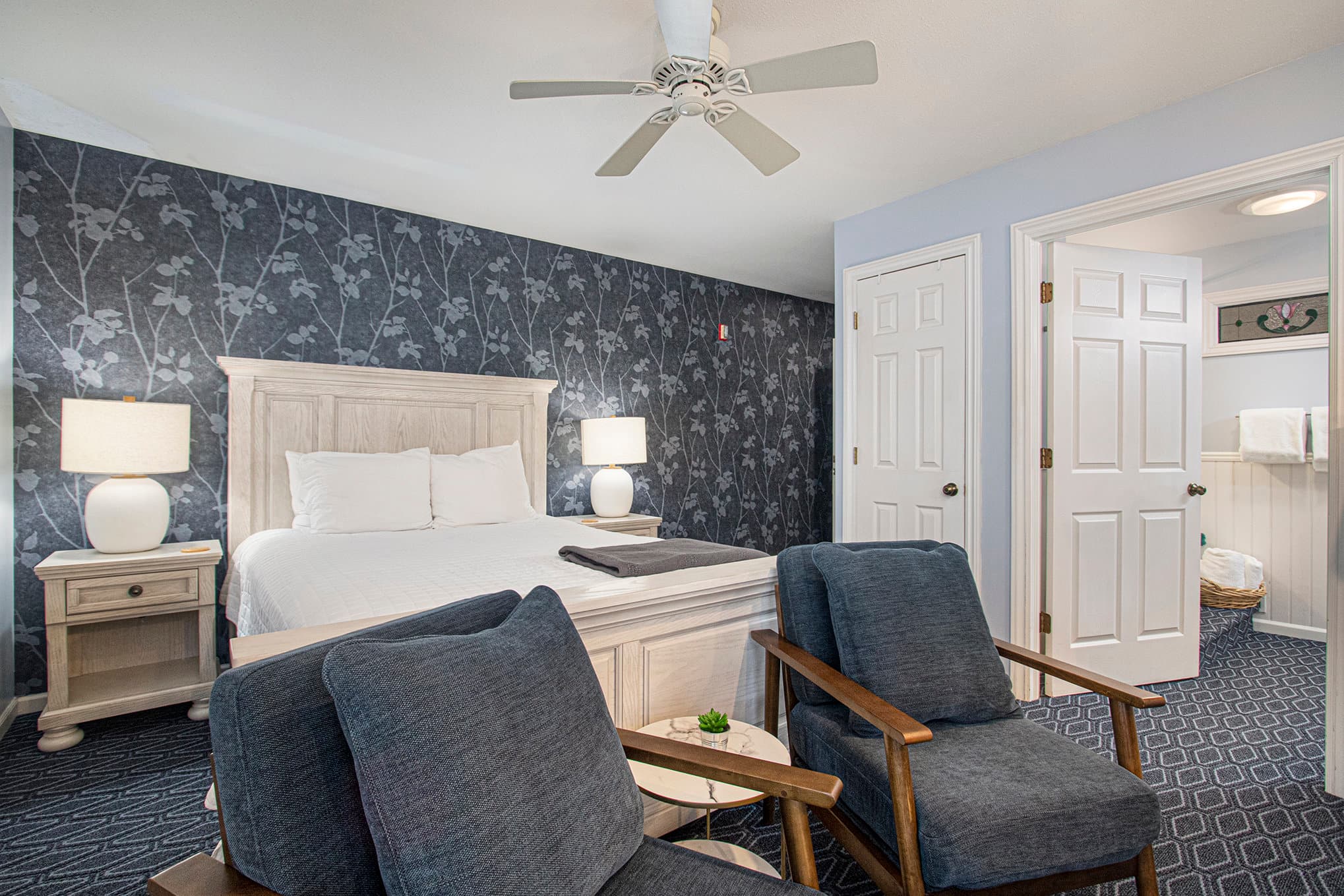 queen bed and two chairs