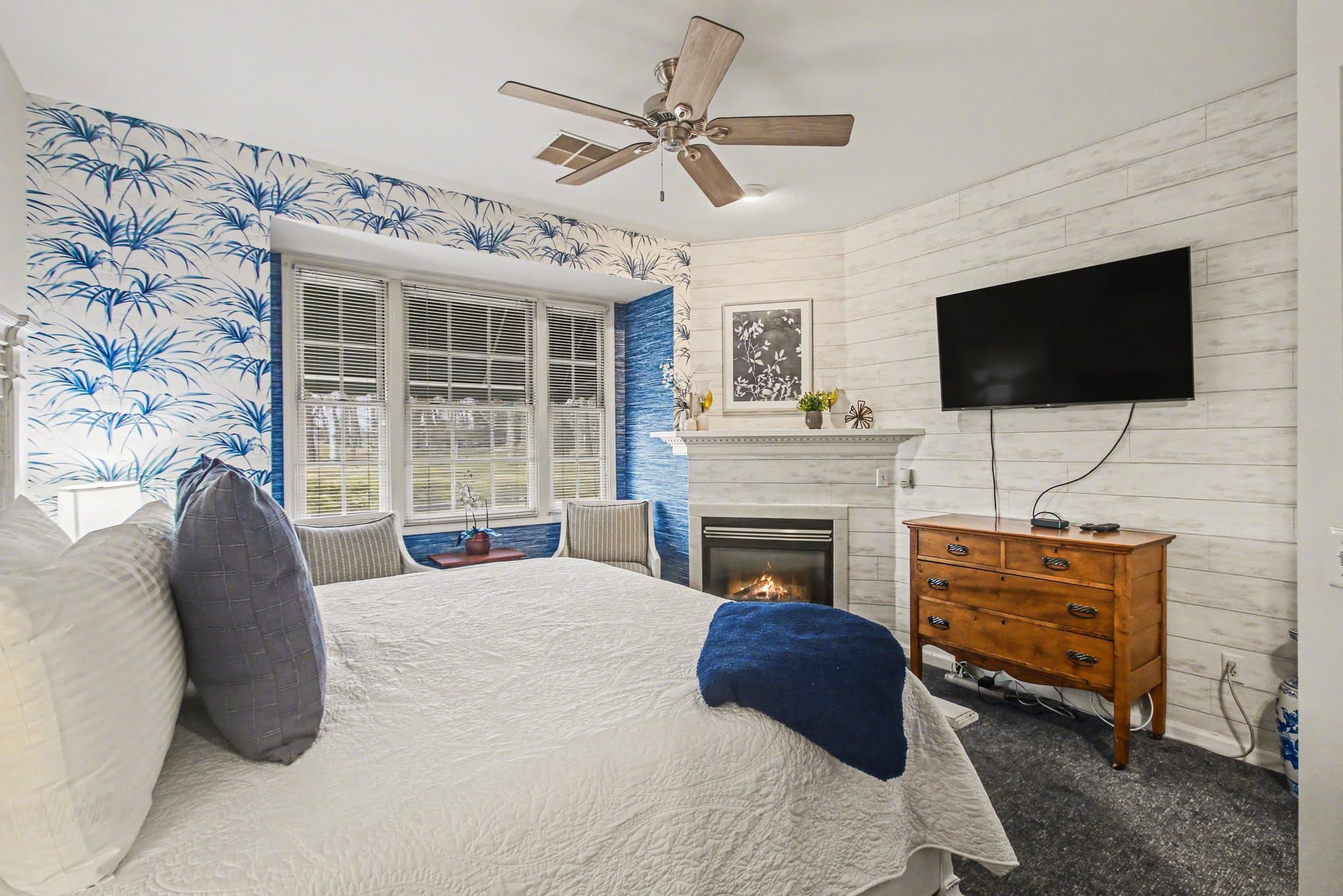 white king bed by fireplace