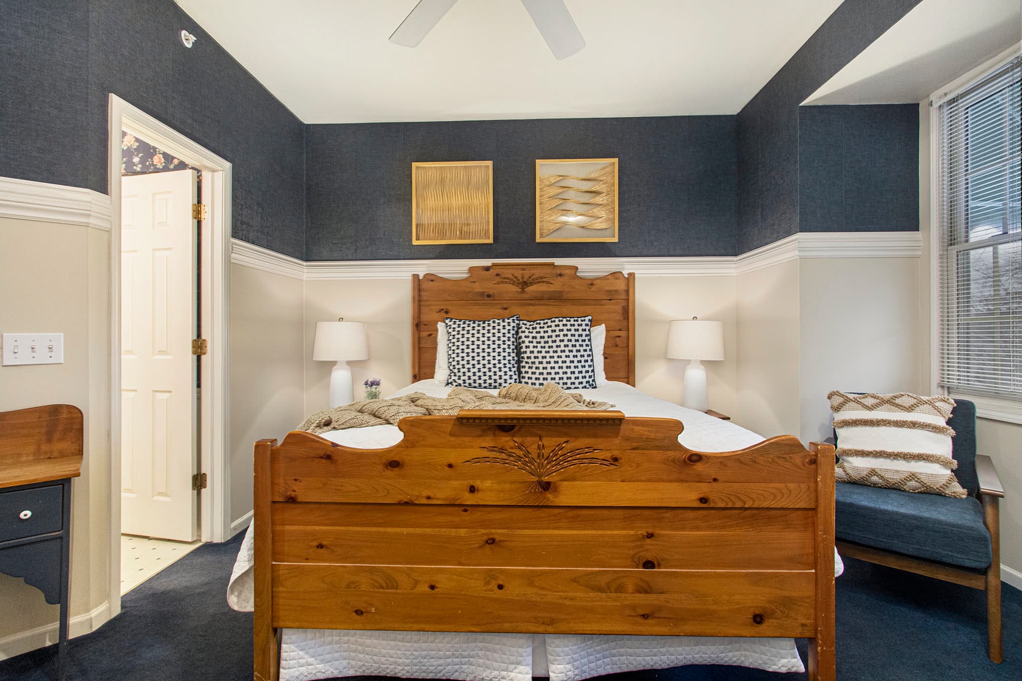 queen bed and bathroom entrance