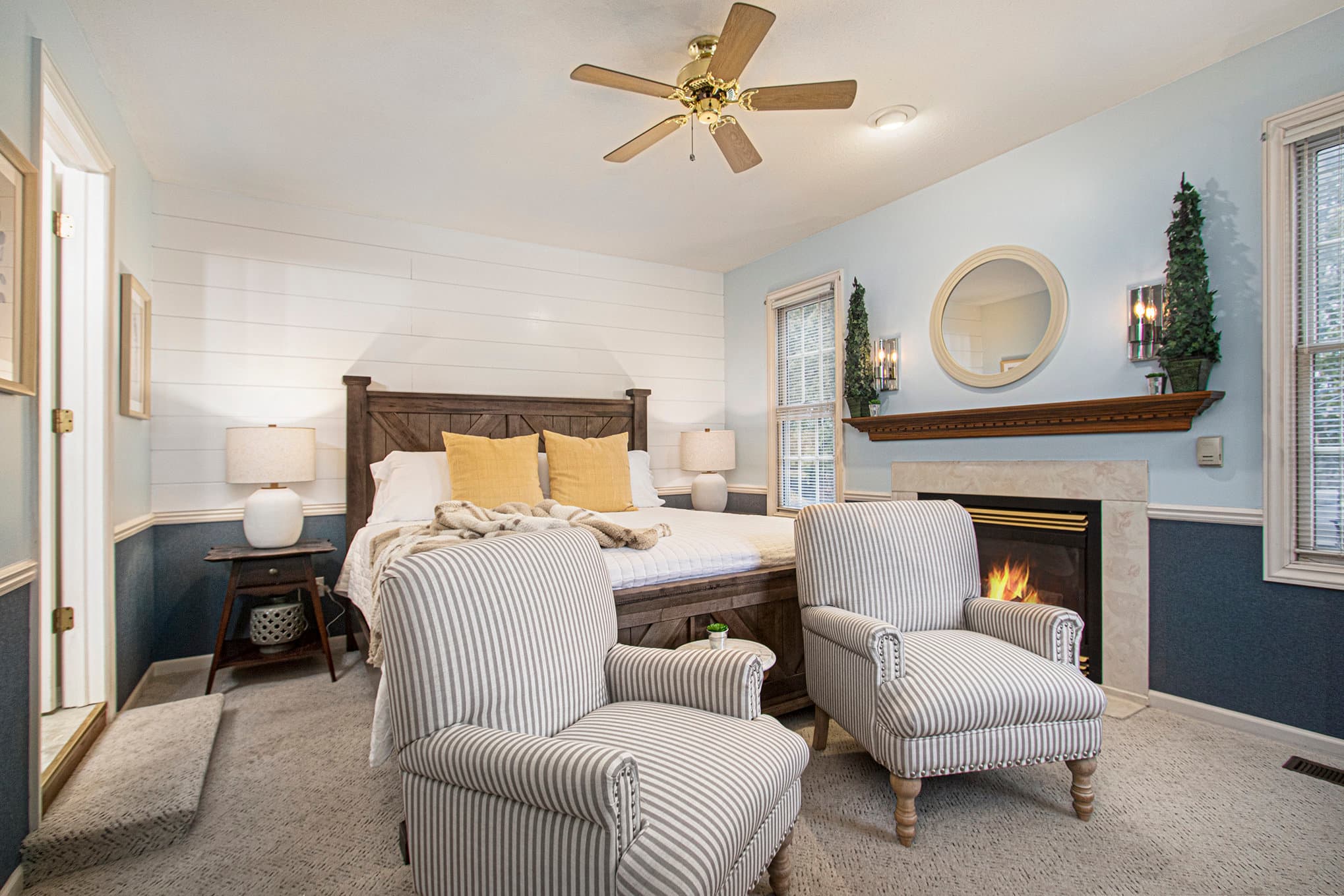 king bed two chairs and fireplace