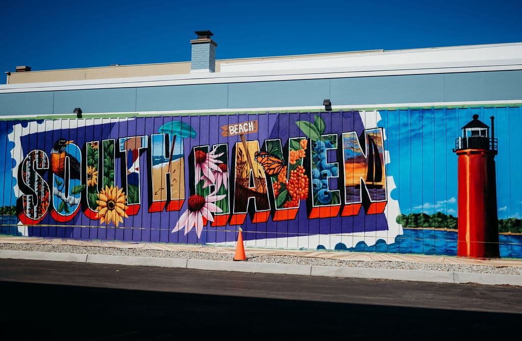 Colorful mural featuring the word "South Haven" with floral elements and a lighthouse. Colorful mural featuring the word "South Haven" with floral elements and a lighthouse.