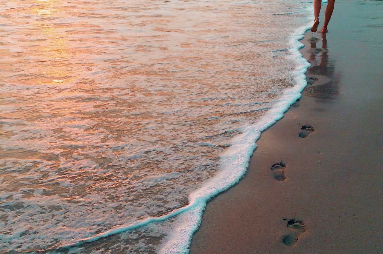 footprints in the sand on a beach