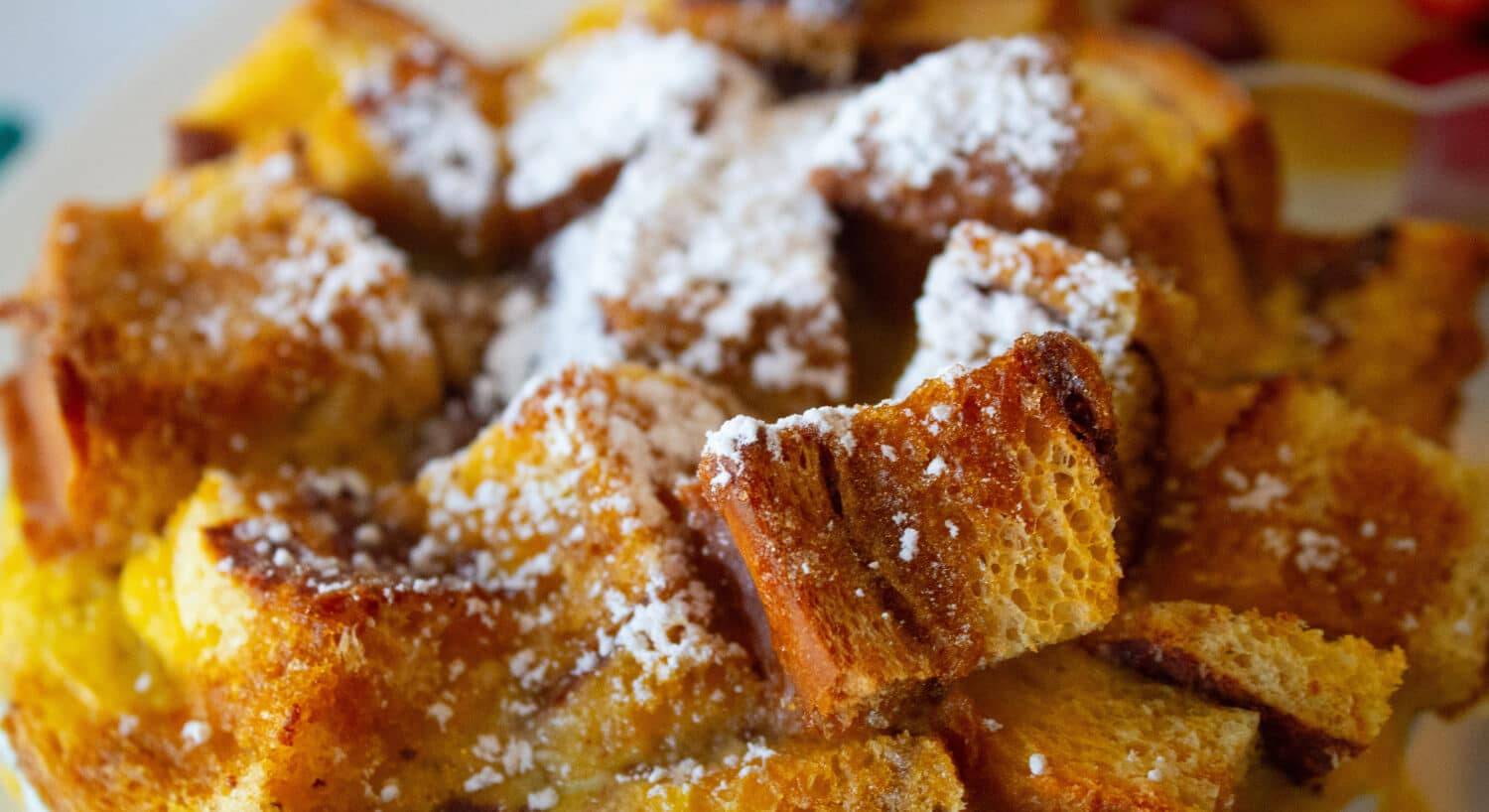 Pieces of golden bread cubes, baked and sprinkled with powdered sugar
